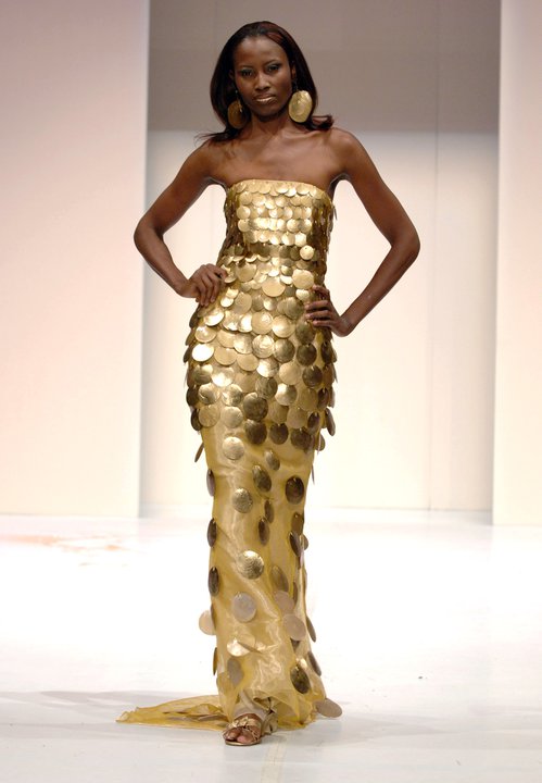 Former fashion model and fashion lawyer Uduak Oduok walking the runway in a Colleen Queen gold couture dress